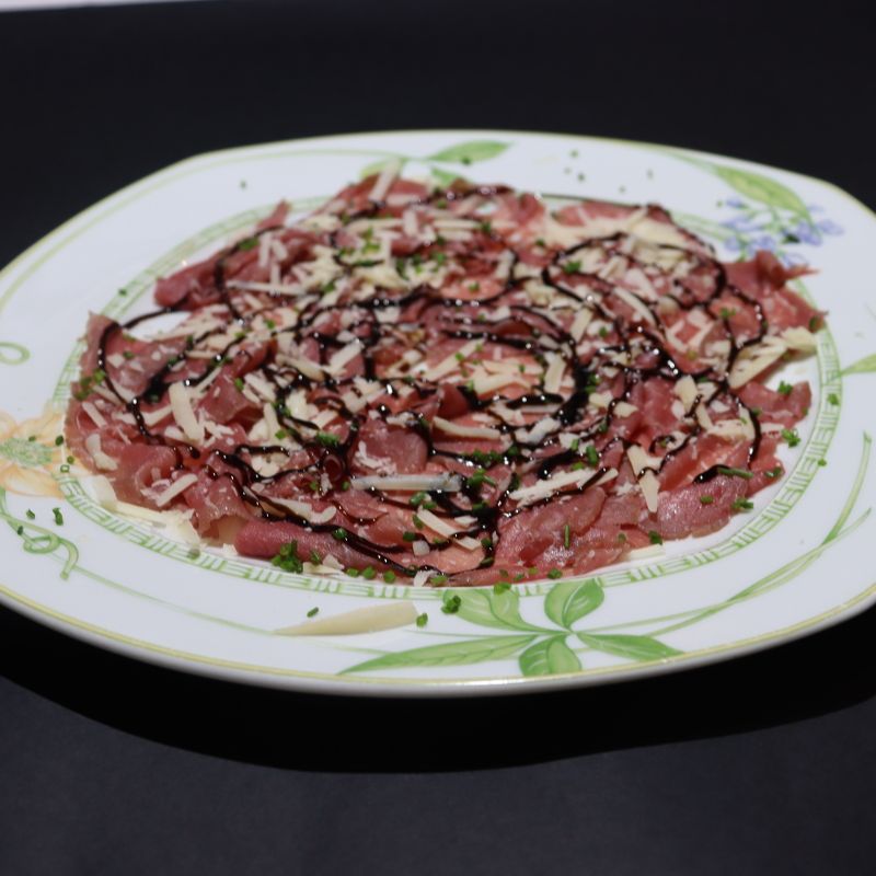 Carpaccio of salted meat with parmesan and balsamic vinegar cream
