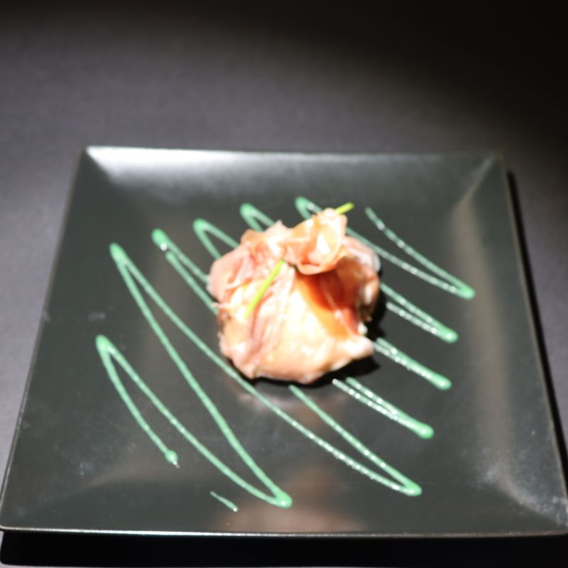 Roll of raw ham with buffalo mozzarella and basil sauce