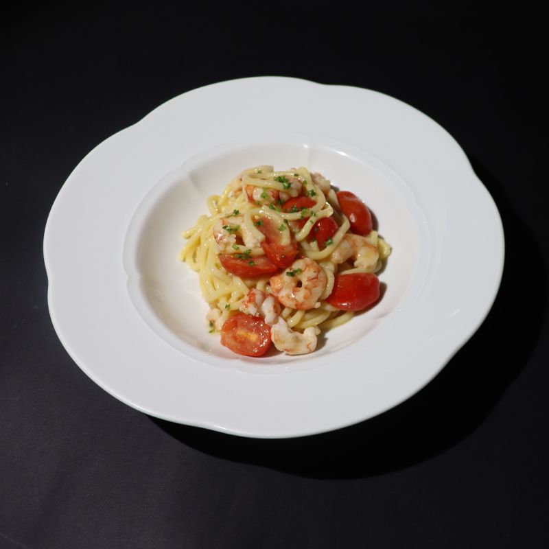 Bigoli with shrimp tails and cherry tomatoes